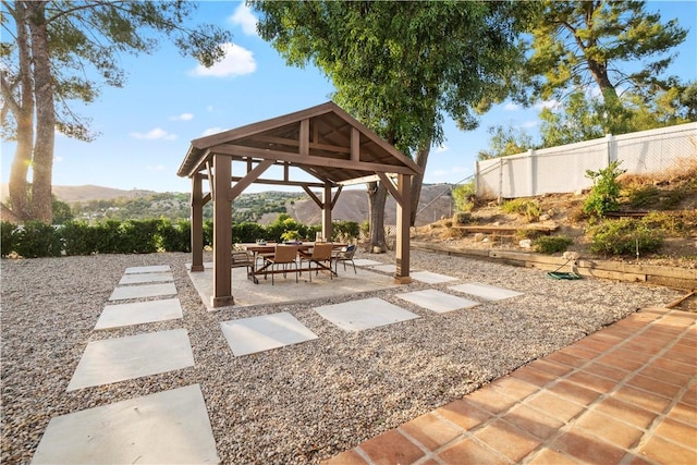 view of patio featuring a gazebo and a mountain view