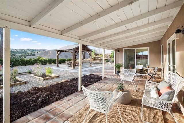 view of patio / terrace featuring a mountain view and a gazebo