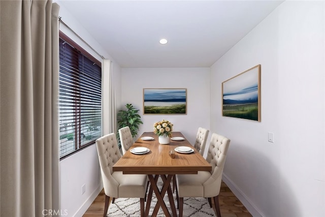 dining space with hardwood / wood-style flooring