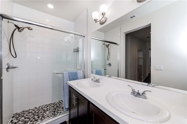 bathroom featuring vanity and a shower with shower door