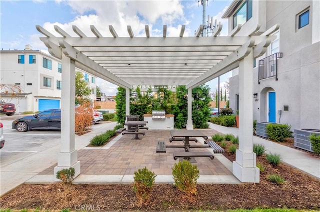 view of patio / terrace with an outdoor kitchen, cooling unit, a pergola, and a grill