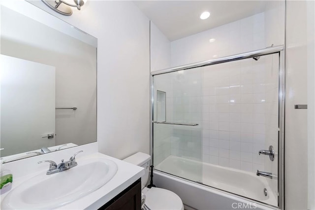 full bathroom featuring toilet, vanity, and combined bath / shower with glass door