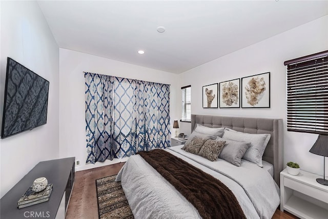 bedroom with dark wood-type flooring