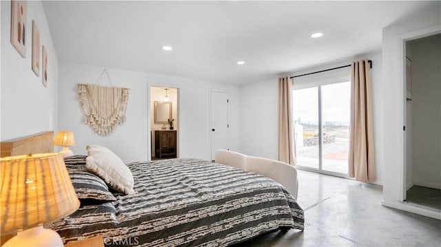 bedroom with connected bathroom, access to exterior, and concrete floors