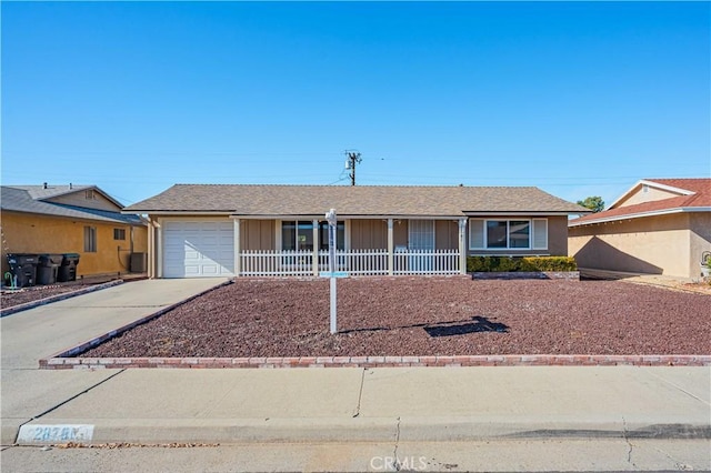 ranch-style home with covered porch and a garage