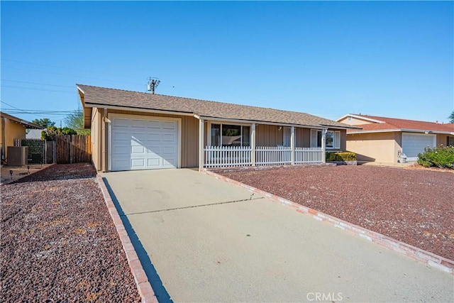 single story home featuring central AC unit and a garage