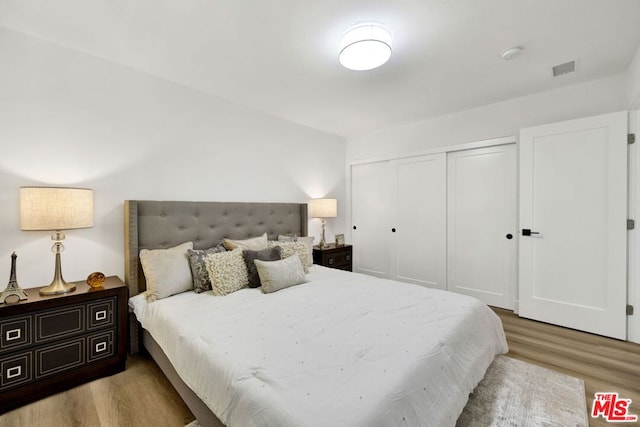 bedroom featuring light hardwood / wood-style flooring and a closet