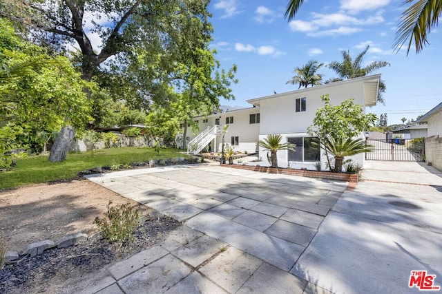 rear view of property with a lawn