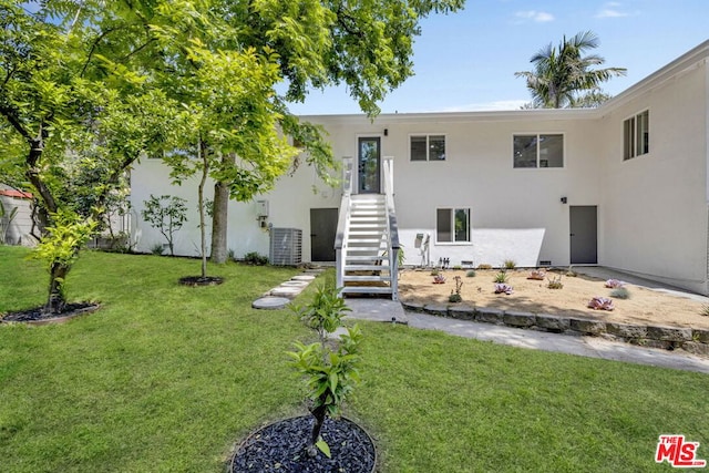 exterior space featuring a yard and central air condition unit