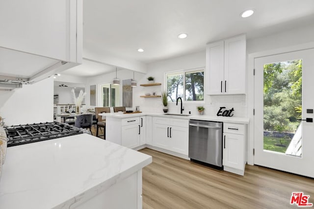 kitchen featuring dishwasher, white cabinetry, a healthy amount of sunlight, and sink