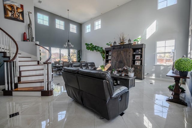 living room with a high ceiling and a notable chandelier