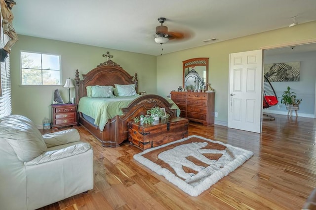 bedroom with hardwood / wood-style floors and ceiling fan