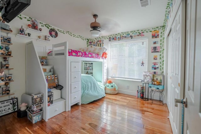 bedroom with wood-type flooring and ceiling fan