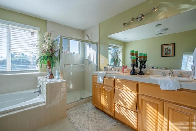 bathroom featuring tile patterned floors, vanity, and plus walk in shower