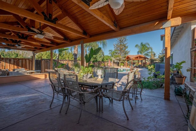 view of patio featuring a fenced in pool, a gazebo, and ceiling fan