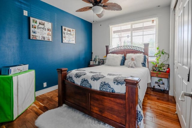 bedroom featuring hardwood / wood-style floors, ceiling fan, and a closet