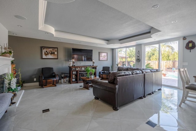 living room featuring a tray ceiling, a textured ceiling, and light tile patterned floors