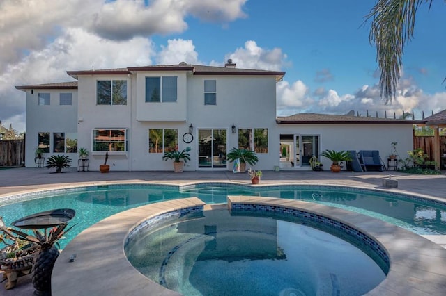 view of pool featuring a patio area and an in ground hot tub