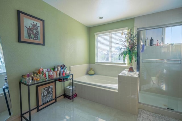 bathroom featuring tile patterned floors and shower with separate bathtub