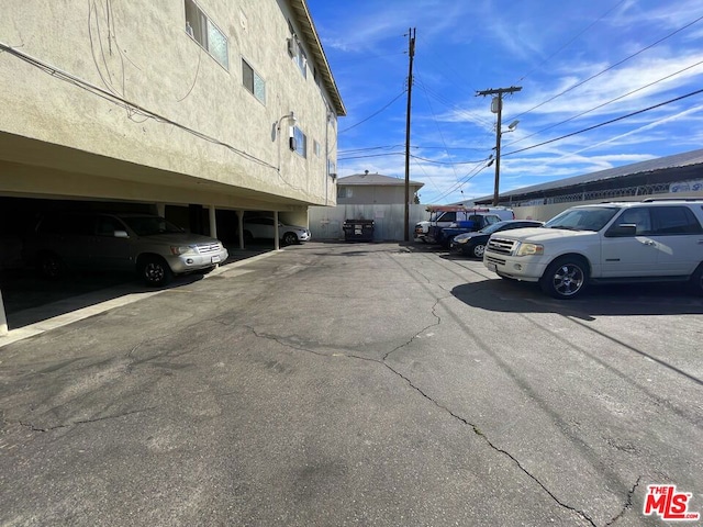 view of parking / parking lot featuring a carport