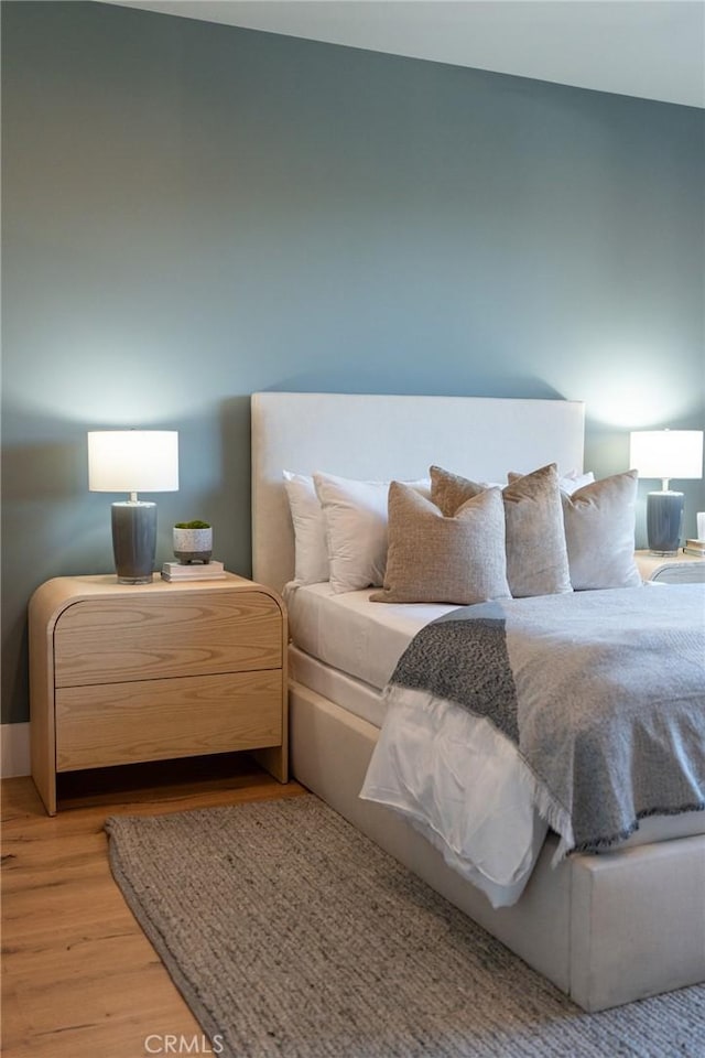 bedroom with light wood-style floors