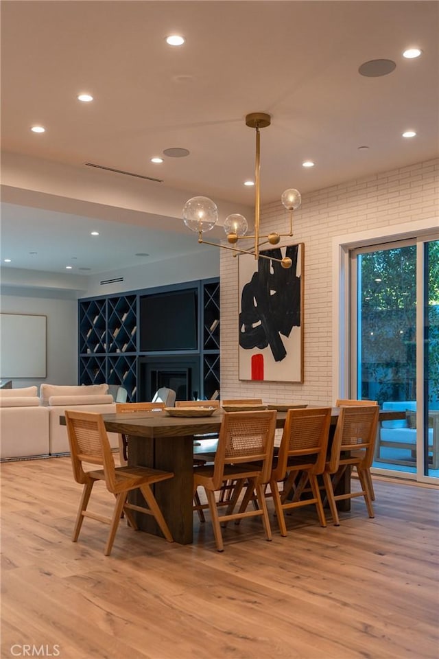 dining room with recessed lighting and light wood-style floors