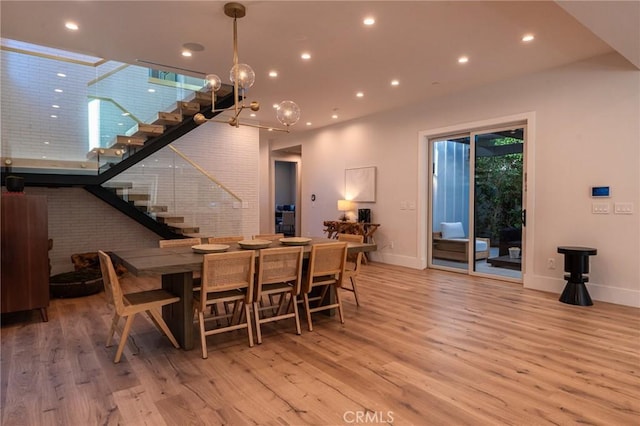 dining space featuring recessed lighting, stairs, baseboards, and wood finished floors