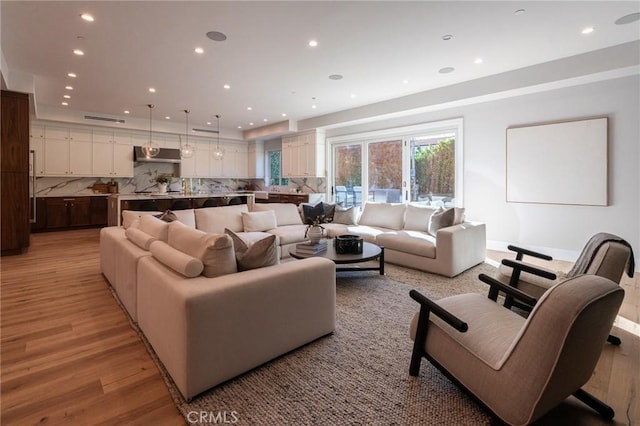 living room featuring recessed lighting and light wood-style floors
