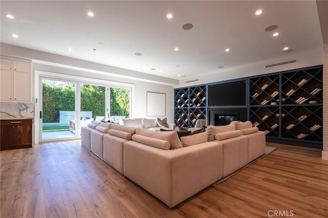 living room with recessed lighting and light wood finished floors