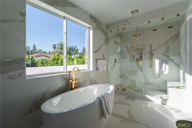 bathroom with shower with separate bathtub