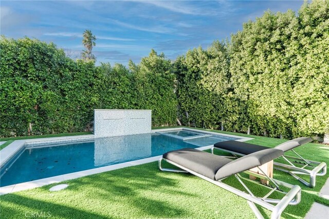 view of swimming pool featuring a yard, a fenced in pool, and a hot tub