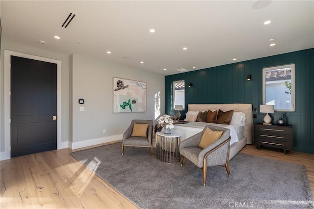 bedroom with wood finished floors, visible vents, and recessed lighting