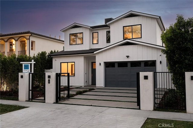 modern farmhouse style home featuring concrete driveway, board and batten siding, a fenced front yard, a garage, and a gate