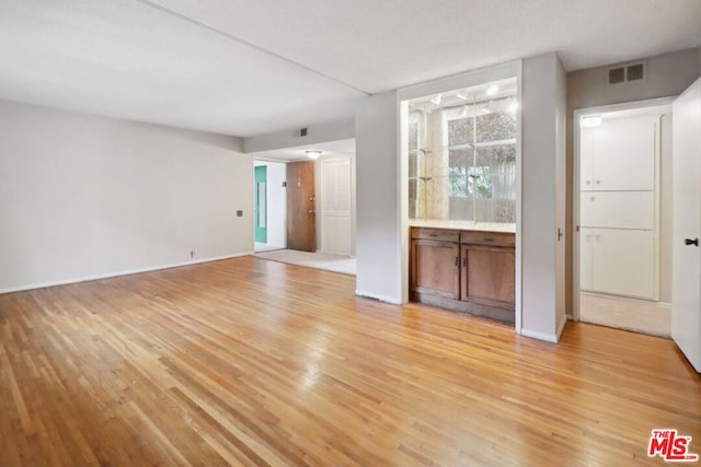 unfurnished living room with light hardwood / wood-style flooring