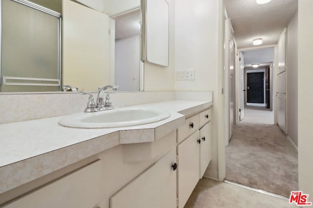 bathroom with vanity and a textured ceiling