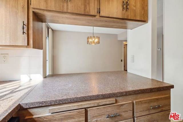 kitchen with a chandelier and hanging light fixtures