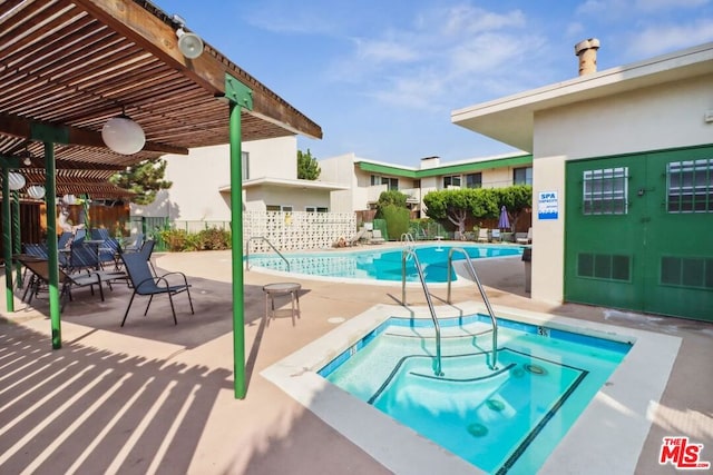 view of pool with a pergola, a patio area, and a hot tub