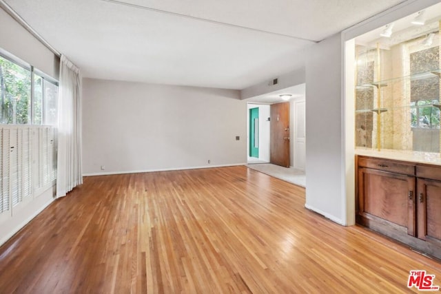 spare room featuring light wood-type flooring