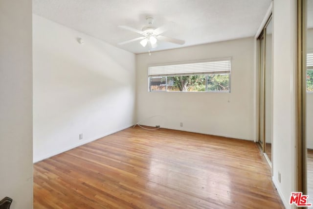 unfurnished bedroom featuring ceiling fan and light wood-type flooring