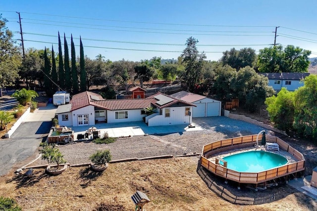 view of pool with a garage and an outdoor structure