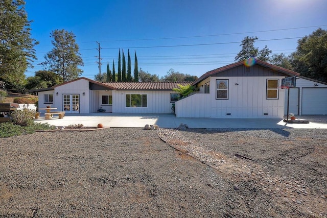 view of front of home with a patio and french doors