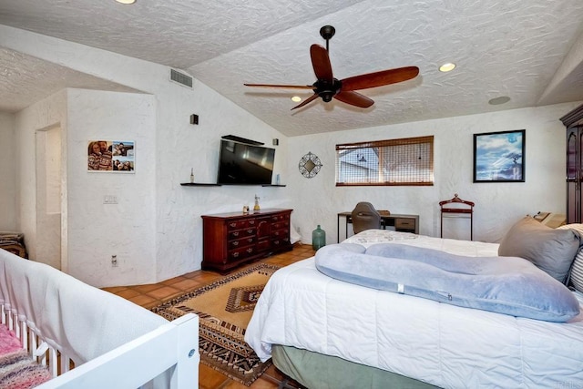 bedroom featuring a textured ceiling, vaulted ceiling, and ceiling fan