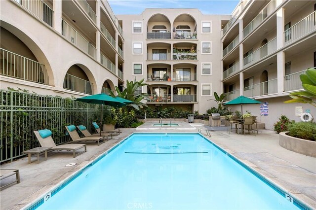 view of pool featuring a patio area and a grill