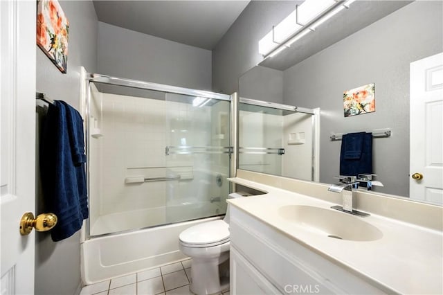 full bathroom featuring tile patterned floors, vanity, enclosed tub / shower combo, and toilet