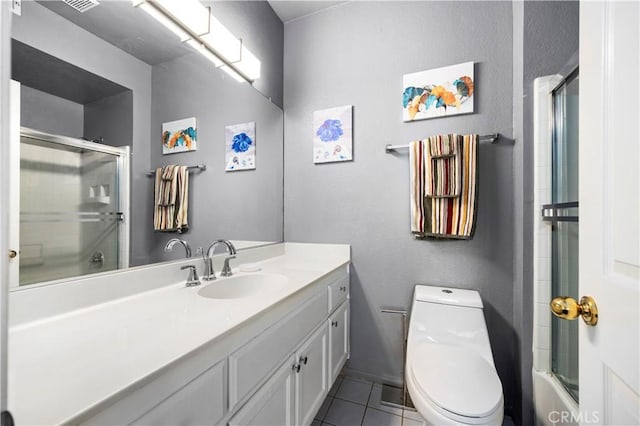 full bathroom featuring tile patterned flooring, vanity, bath / shower combo with glass door, and toilet