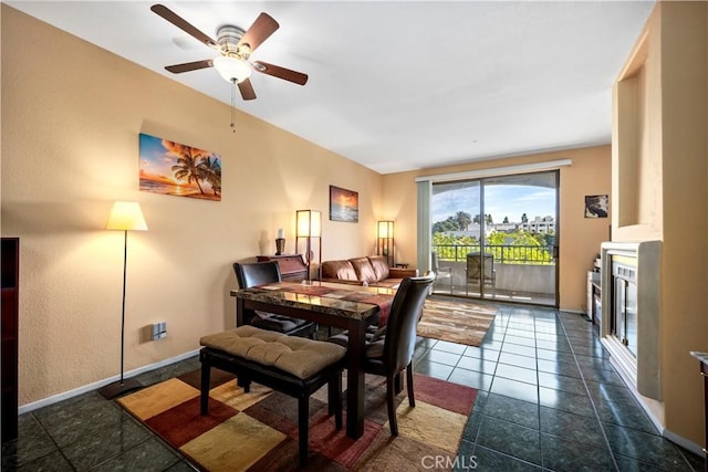 tiled dining area with ceiling fan