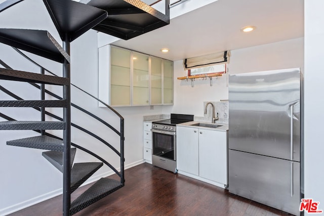 kitchen featuring white cabinetry, stainless steel appliances, dark hardwood / wood-style flooring, and sink