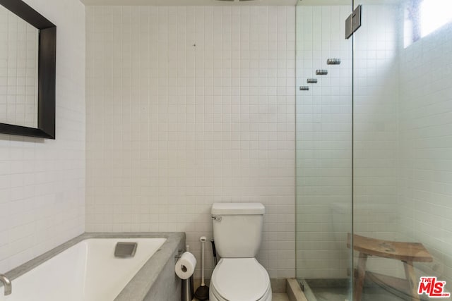 bathroom with independent shower and bath, tile walls, and toilet