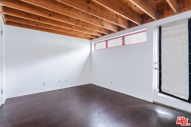 basement featuring dark hardwood / wood-style flooring