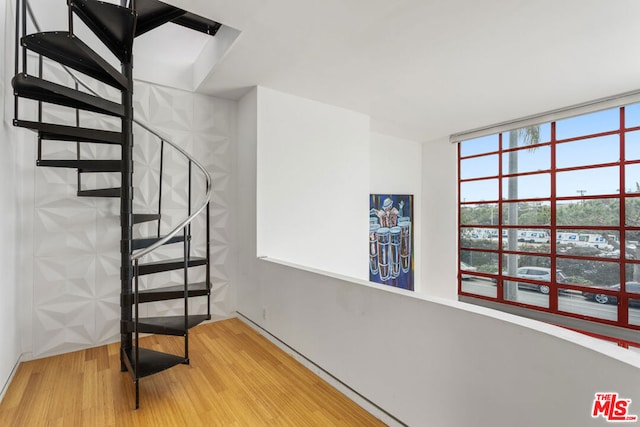 staircase featuring wood-type flooring